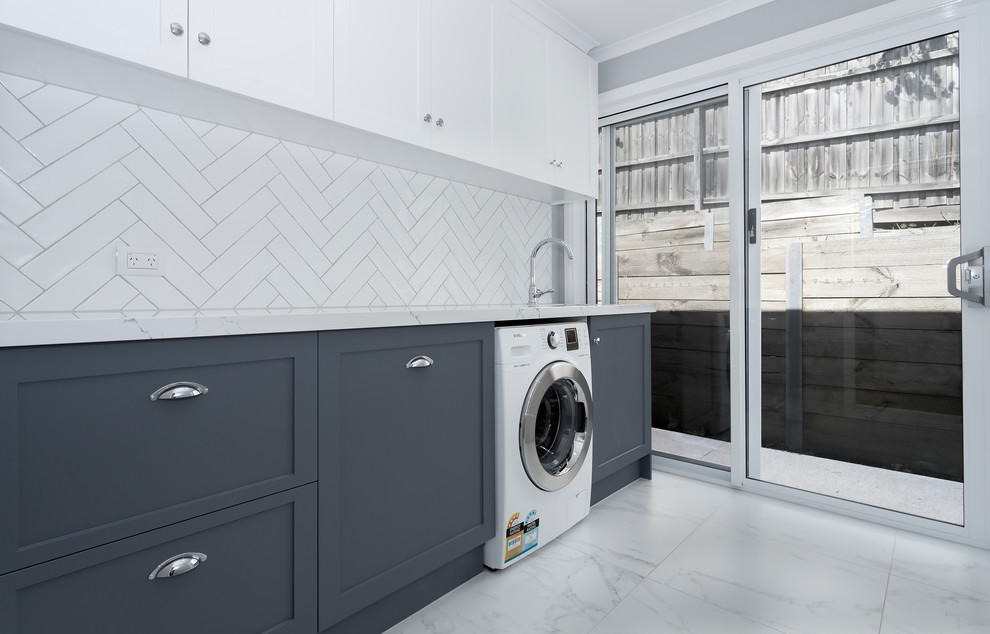 Photo of a mid-sized contemporary single-wall dedicated laundry room in Melbourne with shaker cabinets, quartz benchtops, porcelain floors, an undermount sink and grey cabinets.
