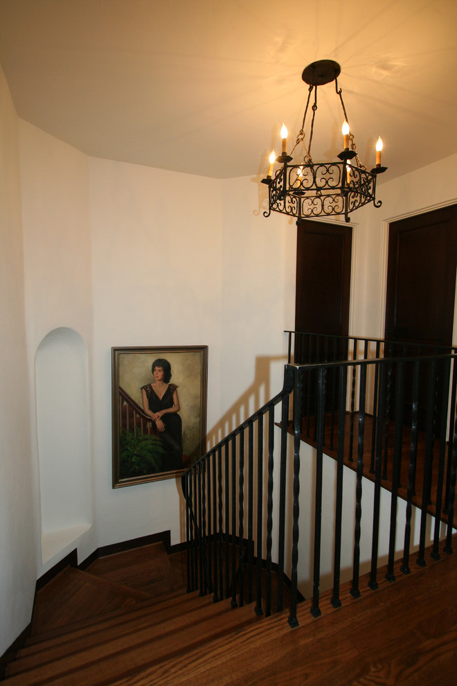 Photo of a mediterranean wood u-shaped staircase in San Diego with wood risers.