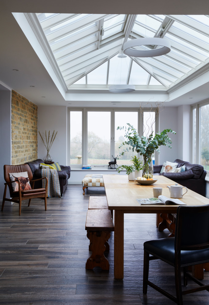 Example of a mid-sized farmhouse dark wood floor and brown floor sunroom design in Essex with a skylight
