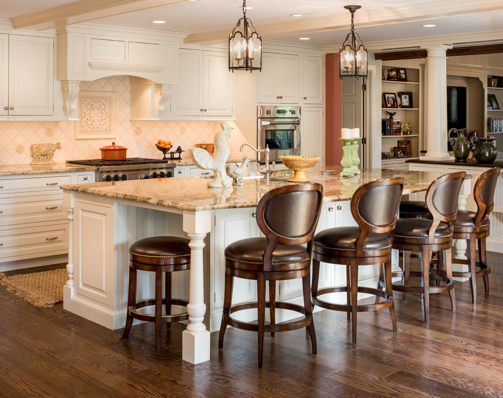 Design ideas for a traditional l-shaped open plan kitchen in Philadelphia with raised-panel cabinets, white cabinets, granite benchtops, beige splashback, ceramic splashback, stainless steel appliances, with island, a drop-in sink and dark hardwood floors.