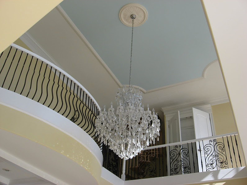 This is an example of a large contemporary hallway in Other with yellow walls.
