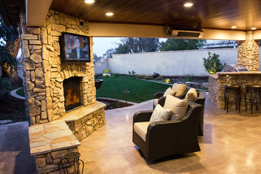 Photo of a mid-sized arts and crafts backyard patio in Los Angeles with a fire feature, tile and a roof extension.