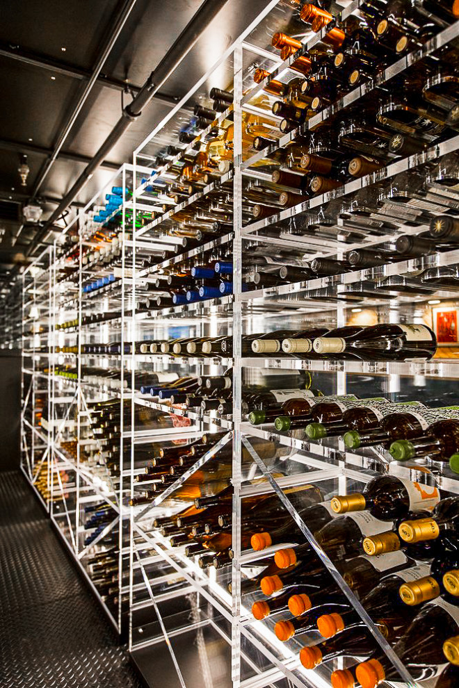 Expansive modern wine cellar in San Francisco with laminate floors, storage racks and black floor.
