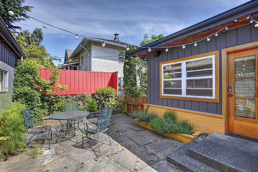Inspiration for a small eclectic one-storey grey exterior in Seattle with mixed siding.