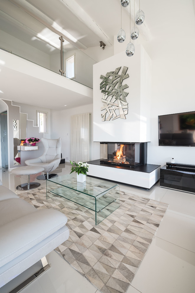This is an example of a contemporary enclosed family room in Marseille with a standard fireplace, a plaster fireplace surround, white walls, a wall-mounted tv and beige floor.