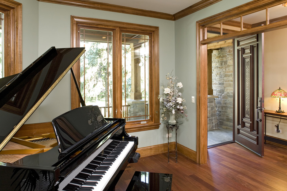 Inspiration for a large arts and crafts open concept living room in Chicago with a music area, green walls, medium hardwood floors, no fireplace and no tv.