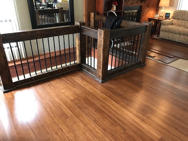Mid-sized mountain style medium tone wood floor and brown floor hallway photo with brown walls