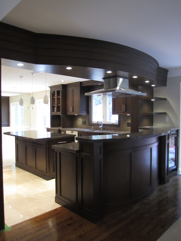 Large transitional u-shaped eat-in kitchen in Toronto with an undermount sink, recessed-panel cabinets, dark wood cabinets, granite benchtops, black splashback, glass tile splashback, stainless steel appliances and marble floors.