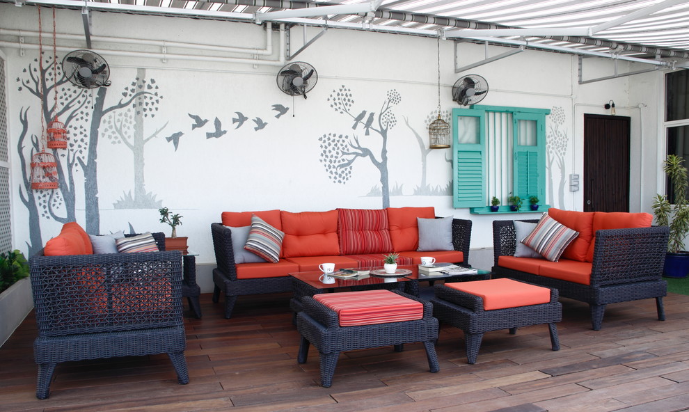 Mid-sized eclectic deck in Mumbai with an awning.