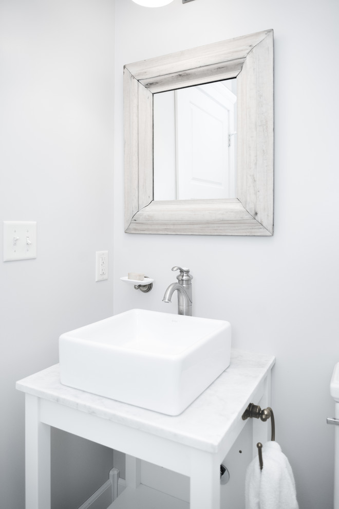 Photo of a country powder room in Kansas City with a vessel sink, open cabinets, white cabinets, white walls and white benchtops.