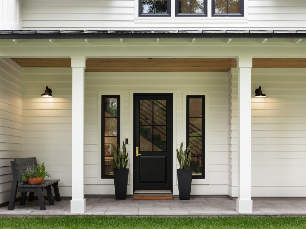 Woodland - Front door and porch of modern luxury farmhouse in Pass Christian Mississippi photographed for Watters Architecture by Birmingham Alabama based architectural and interiors photographer Tommy Daspit.