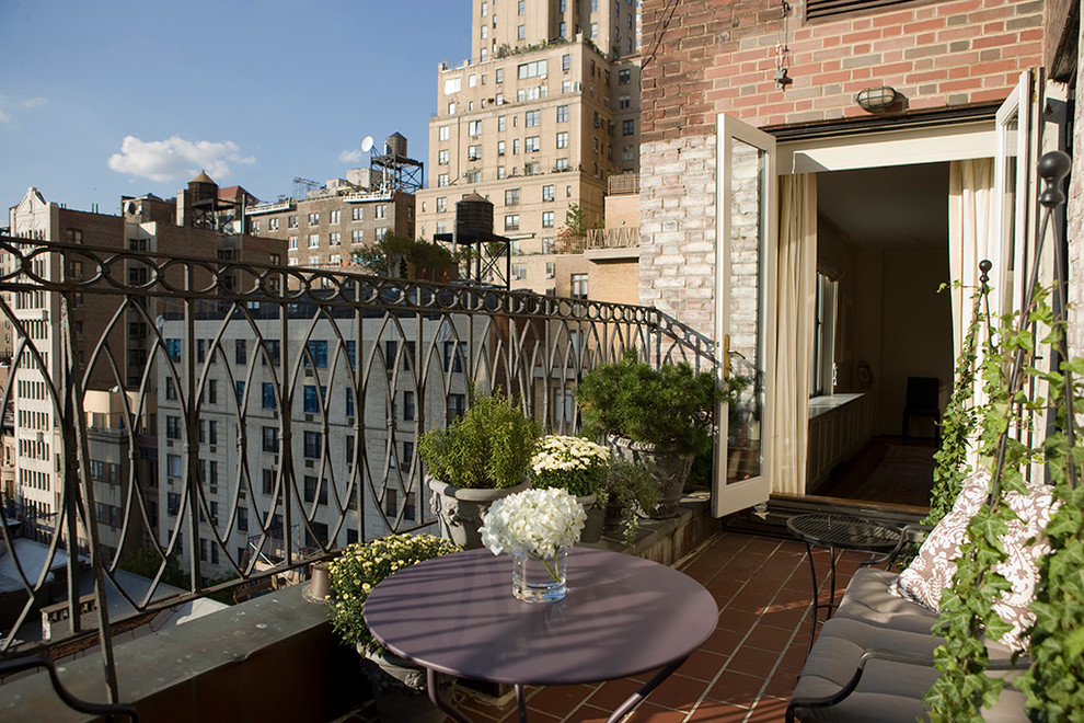 This is an example of a traditional balcony in New York with a container garden and no cover.