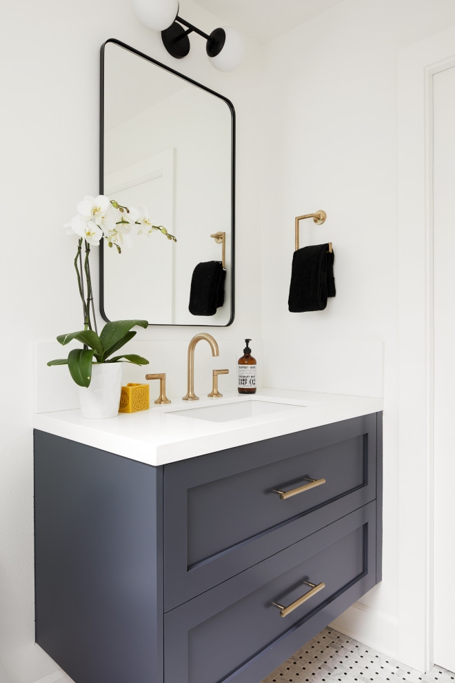 Inspiration for a small country powder room in San Francisco with shaker cabinets, blue cabinets, a one-piece toilet, white walls, marble floors, an undermount sink, quartzite benchtops, black floor, white benchtops and a floating vanity.