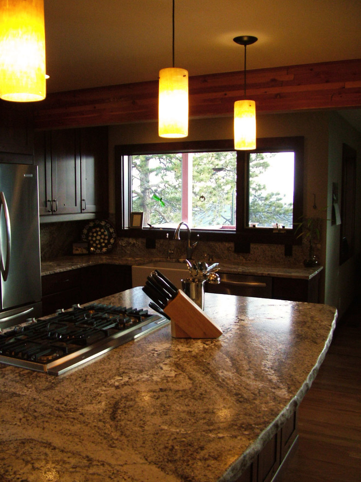 Example of a large mountain style u-shaped medium tone wood floor open concept kitchen design in Denver with a farmhouse sink, flat-panel cabinets, dark wood cabinets, granite countertops, gray backsplash, stainless steel appliances and an island