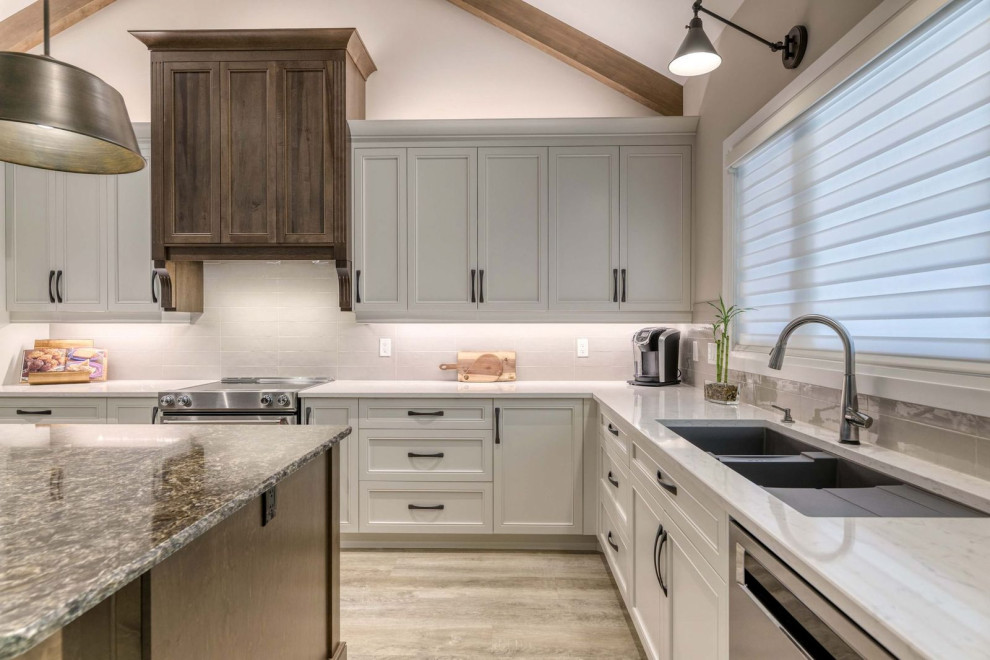 Inspiration for a large transitional eat-in kitchen remodel with an undermount sink, shaker cabinets, quartz countertops, porcelain backsplash, stainless steel appliances and an island