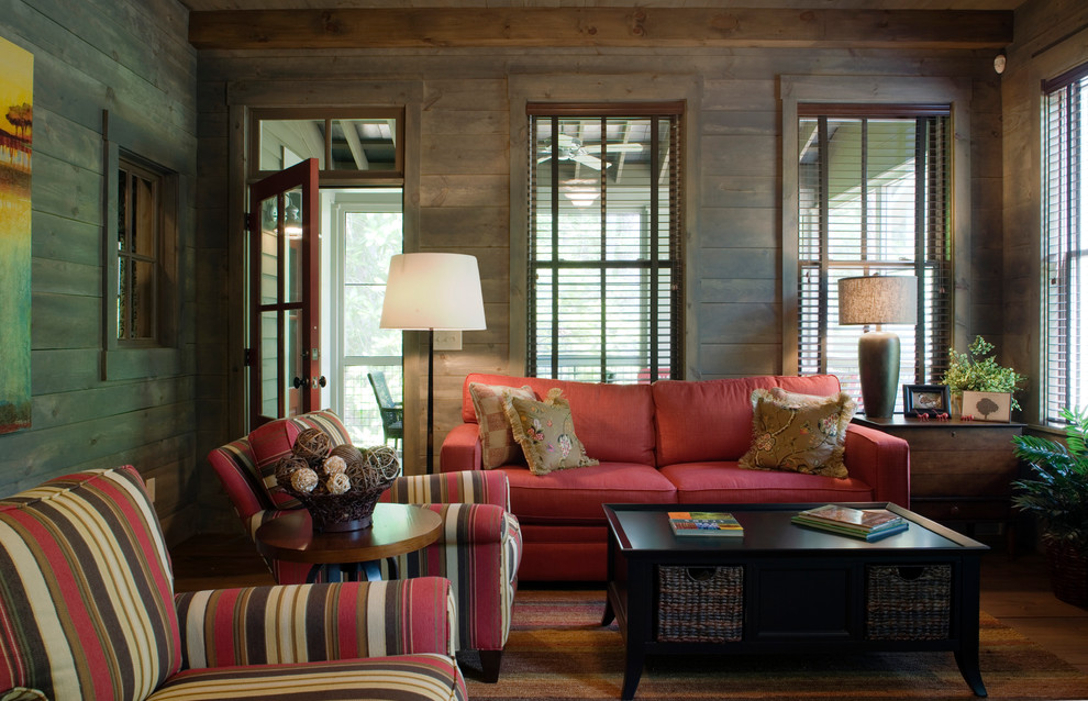 Inspiration for a country enclosed family room in Atlanta with brown walls and dark hardwood floors.
