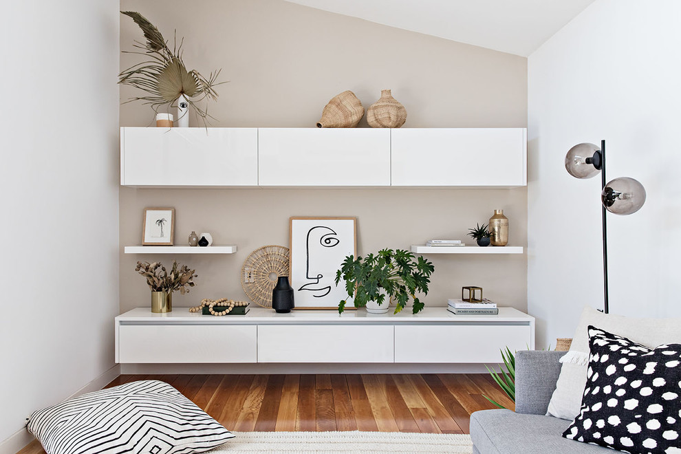 Inspiration for a mid-sized beach style open concept family room in Sydney with white walls, medium hardwood floors, no fireplace, no tv and brown floor.