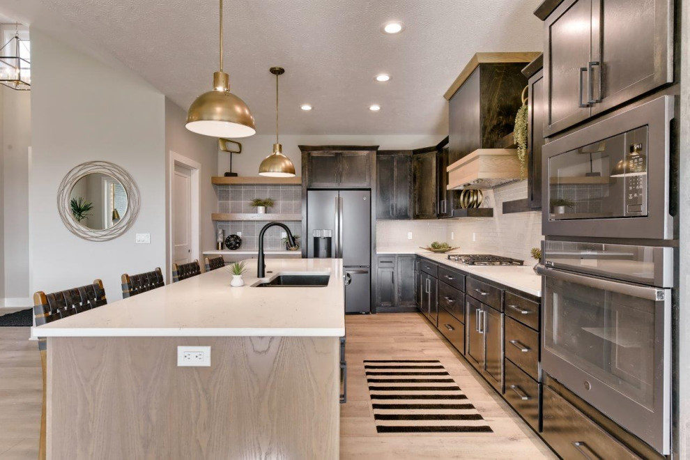 Inspiration for a transitional l-shaped open concept kitchen remodel with shaker cabinets, white backsplash, an island and white countertops