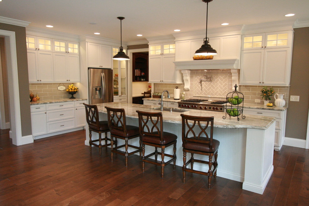 Open concept kitchen - large transitional l-shaped medium tone wood floor open concept kitchen idea in Cincinnati with an undermount sink, flat-panel cabinets, white cabinets, granite countertops, gray backsplash, subway tile backsplash, stainless steel appliances and an island