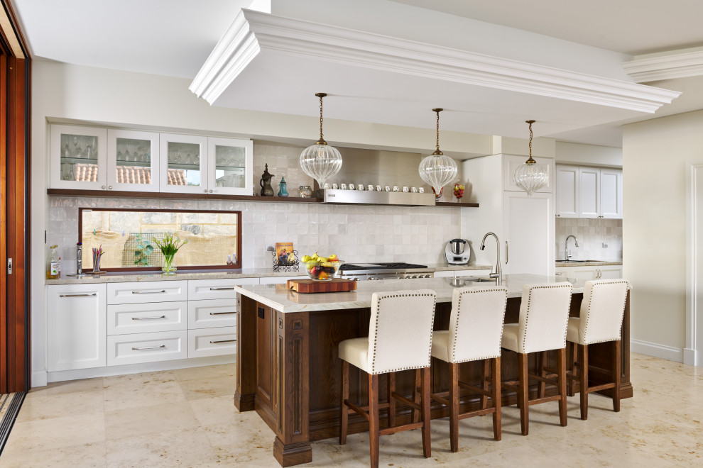 Design ideas for a traditional galley kitchen in Perth with an undermount sink, recessed-panel cabinets, white cabinets, white splashback, stainless steel appliances, with island, beige floor and beige benchtop.