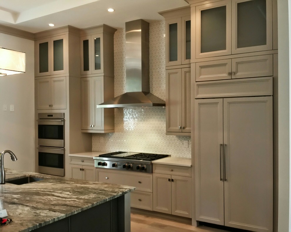 Example of a transitional eat-in kitchen design in Miami with recessed-panel cabinets, beige cabinets and an island