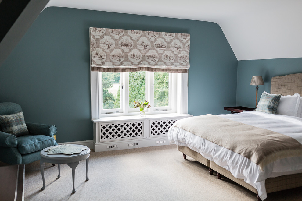 Photo of a large traditional guest bedroom in London with blue walls and carpet.