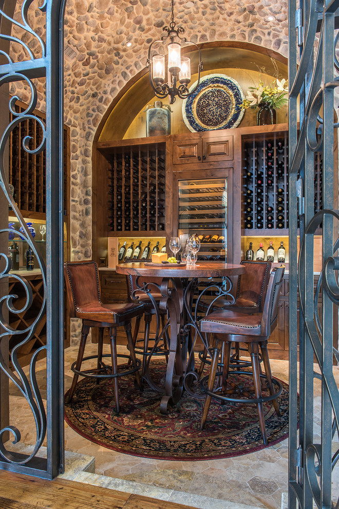 Expansive country wine cellar in Dallas with limestone floors and display racks.