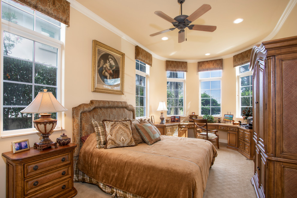 Inspiration for a mediterranean carpeted and beige floor bedroom remodel in Miami with beige walls