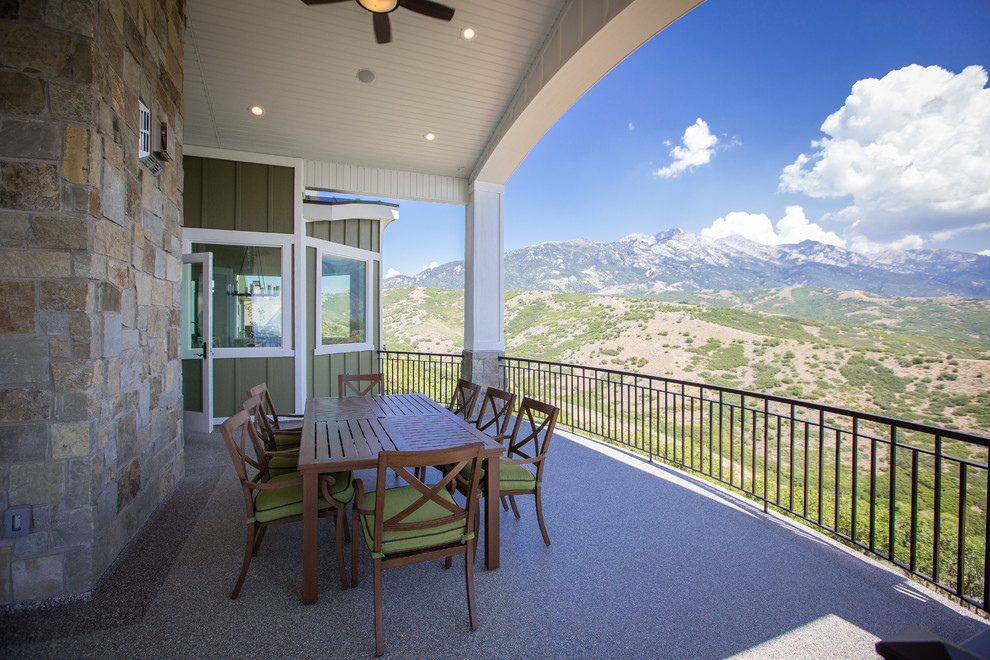 This is an example of a large backyard patio in Salt Lake City with a roof extension.