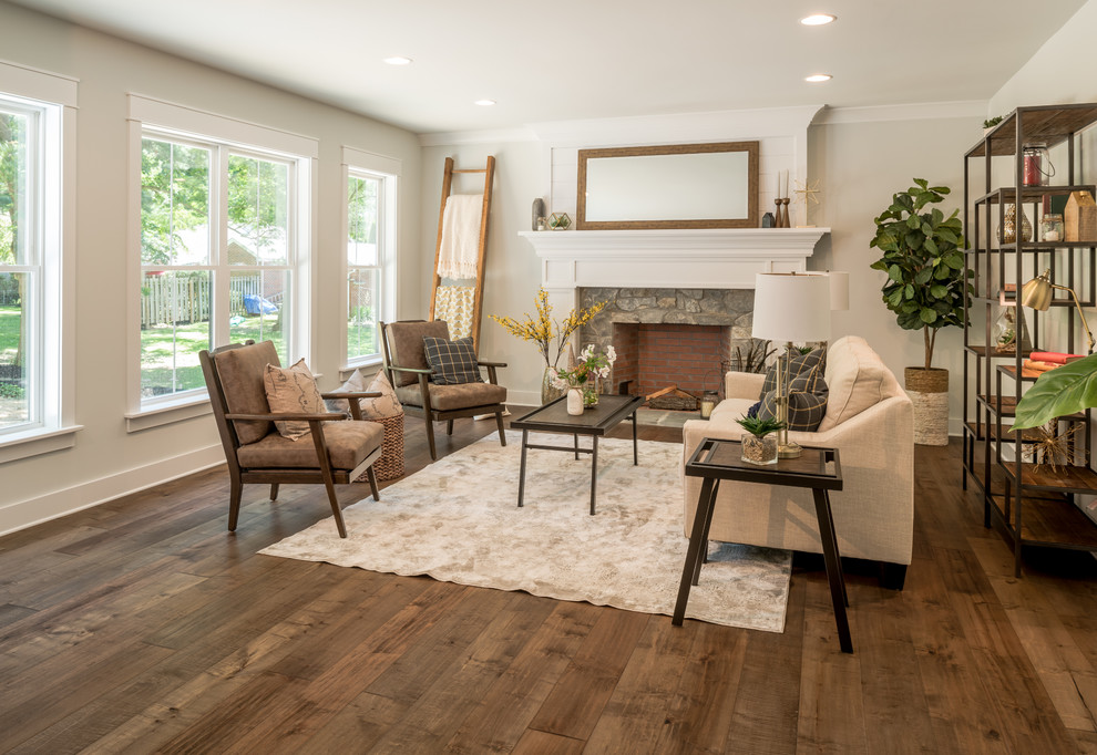 Country living room in Other with grey walls, dark hardwood floors, a standard fireplace, a stone fireplace surround and brown floor.