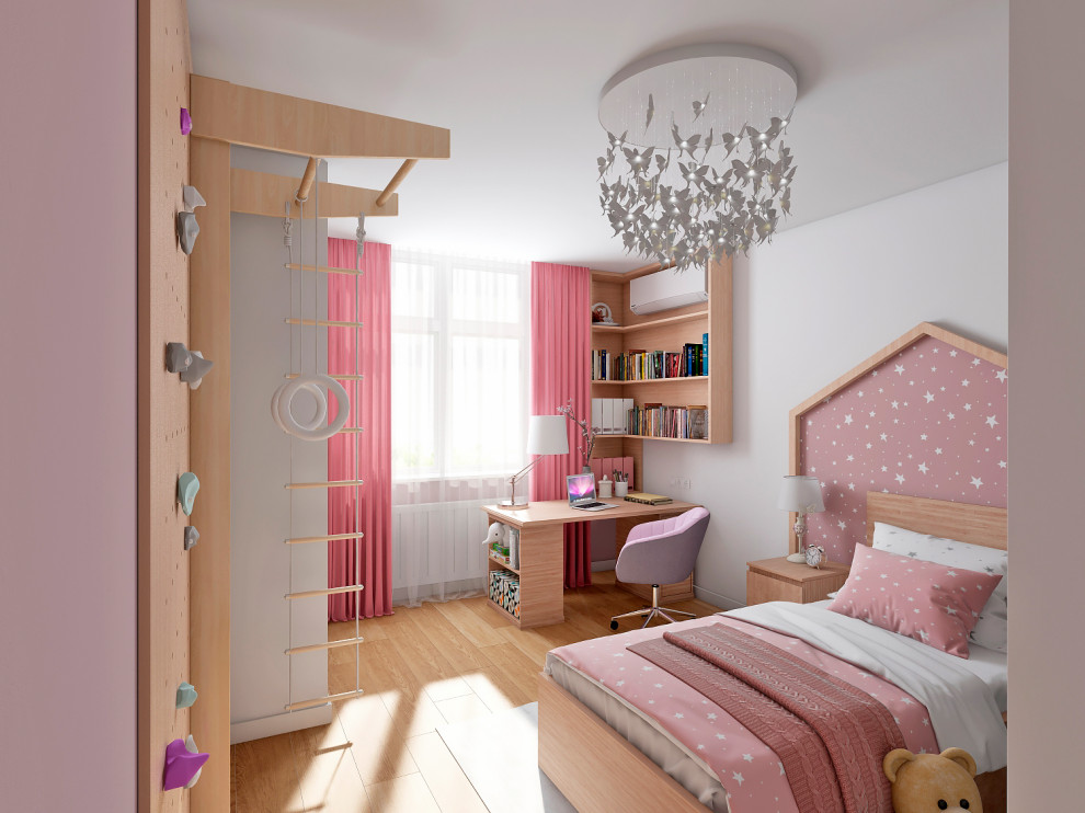 Esempio di una piccola cameretta per bambini da 4 a 10 anni con pareti bianche, pavimento in laminato, pavimento marrone e pareti in legno