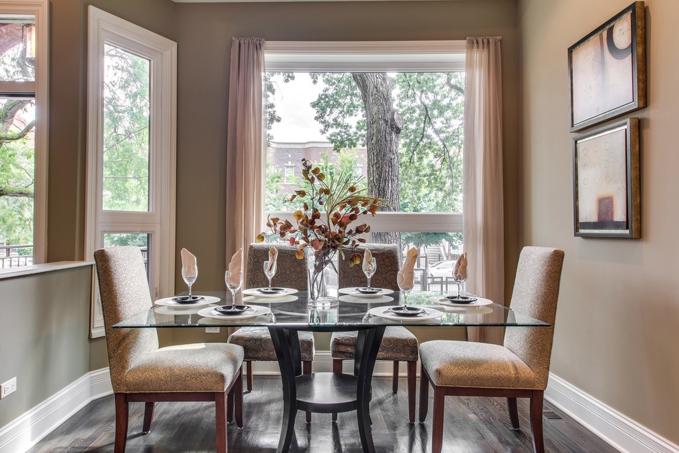 Transitional dining room in Chicago with brown walls and dark hardwood floors.