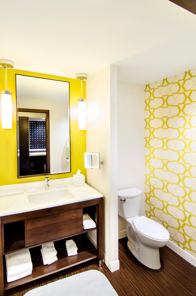 This is an example of a contemporary powder room in Chicago with open cabinets, dark wood cabinets and yellow walls.