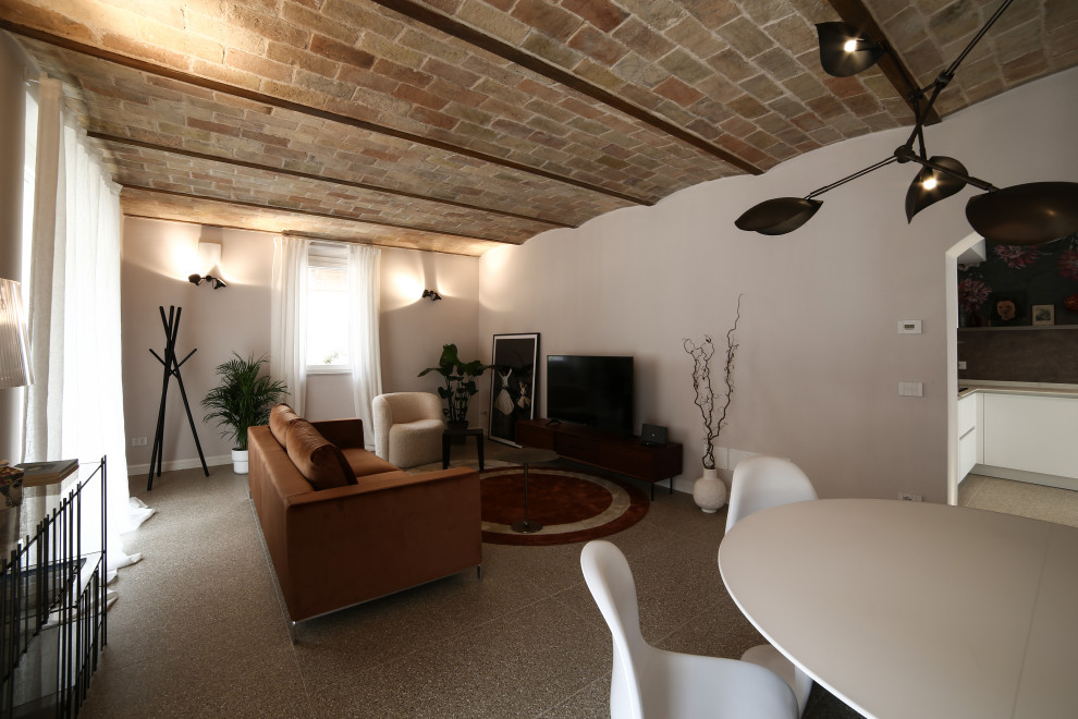 This is an example of a mid-sized contemporary living room in Bologna with ceramic floors, vaulted and wallpaper.