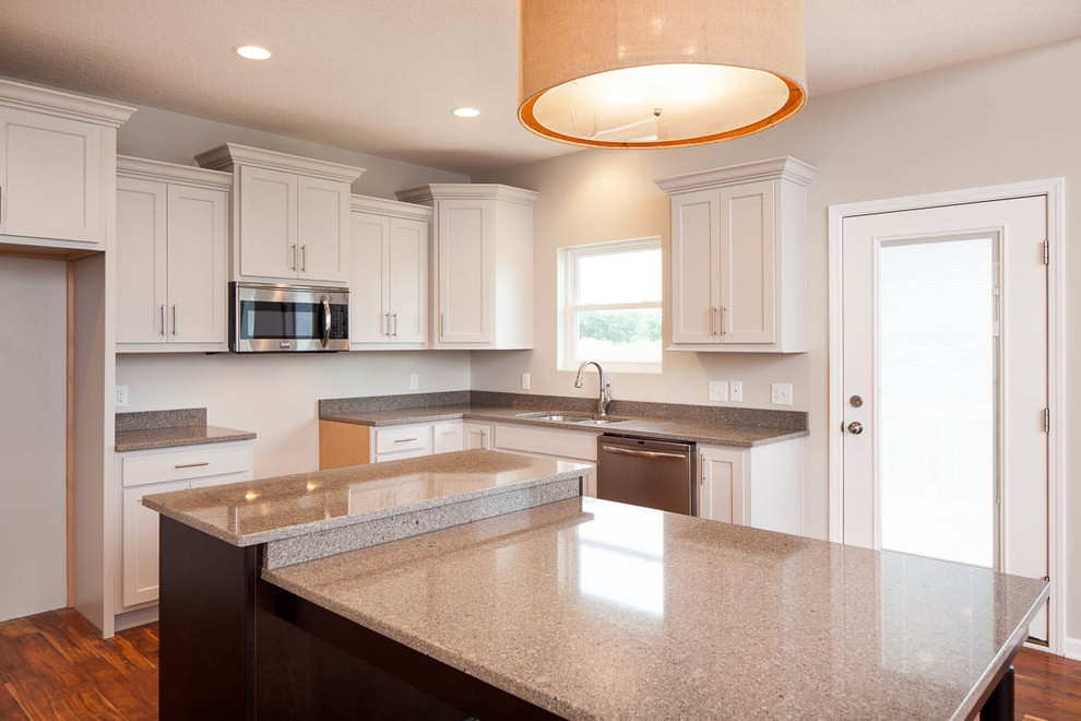 Transitional medium tone wood floor eat-in kitchen photo in Chicago with a double-bowl sink, white cabinets, quartzite countertops, stainless steel appliances, an island and flat-panel cabinets