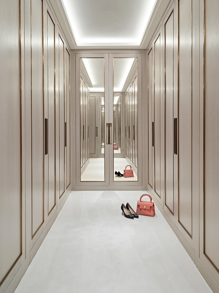 Contemporary women's walk-in wardrobe in Other with recessed-panel cabinets, beige cabinets and white floor.