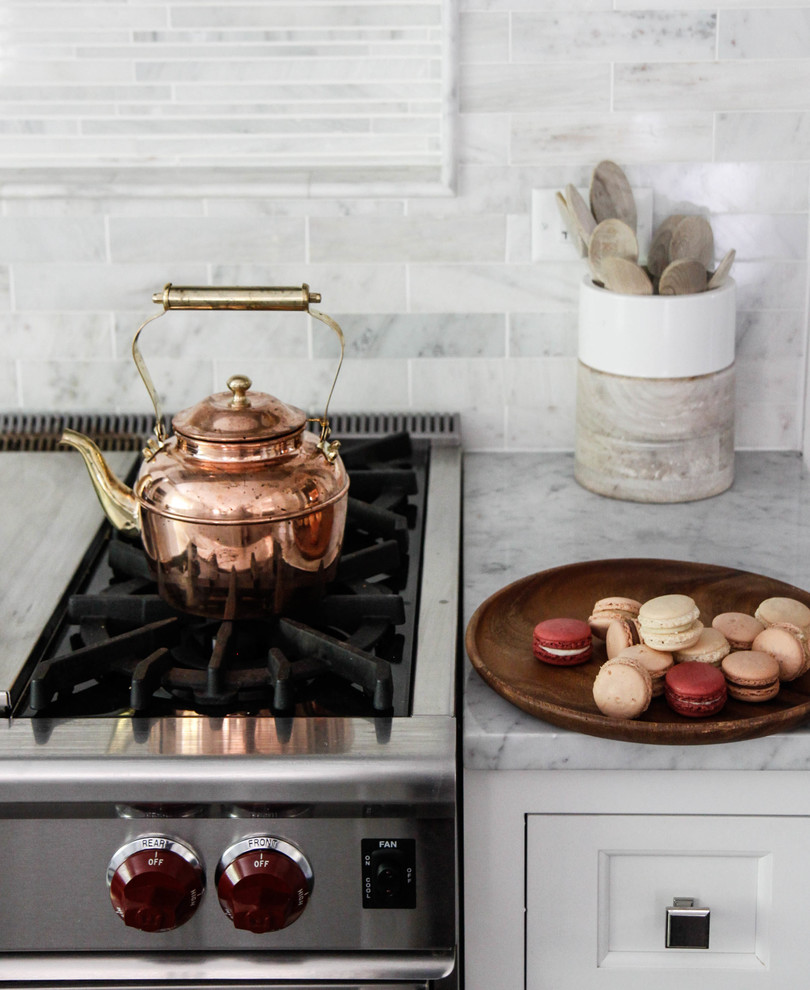 Inspiration for a large transitional l-shaped dark wood floor eat-in kitchen remodel in Chicago with an undermount sink, flat-panel cabinets, white cabinets, marble countertops, white backsplash, stone tile backsplash, stainless steel appliances and an island