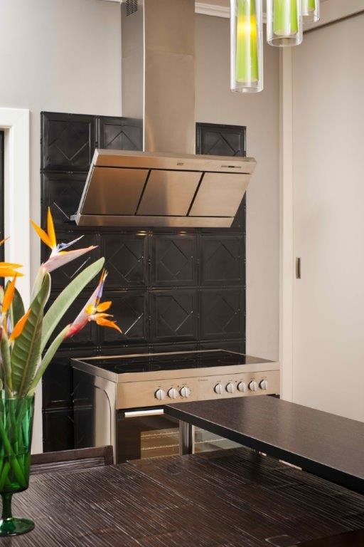 Inspiration for an eclectic eat-in kitchen in Adelaide with black splashback, metal splashback and stainless steel appliances.