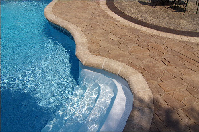 Example of a mid-sized transitional backyard custom-shaped and concrete paver lap pool design in Toronto