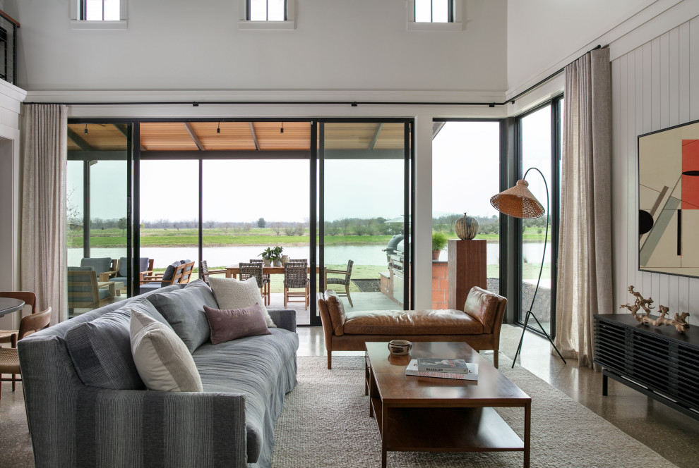 Martindale Water Ski Retreat - Living room - large contemporary open concept concrete floor and wainscoting living room idea in Austin with white walls and a wall-mounted tv