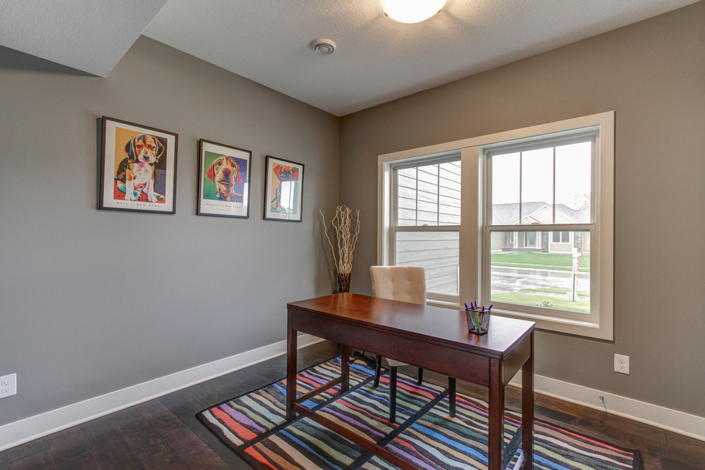 This is an example of a transitional home office in Other with grey walls, dark hardwood floors and a freestanding desk.