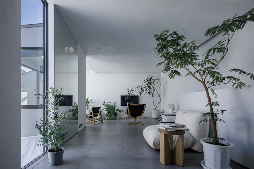 Cette image montre un salon design avec un sol en carrelage de porcelaine.