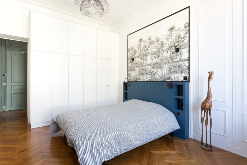 This is an example of a contemporary bedroom in Paris with panelled walls and wallpapered walls.