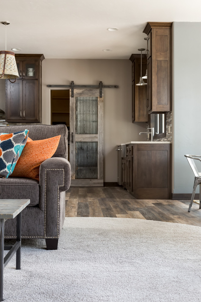 Inspiration for a mid-sized transitional open concept and l-shaped vinyl floor and brown floor eat-in kitchen remodel with a farmhouse sink, shaker cabinets, dark wood cabinets, quartz countertops, multicolored backsplash, matchstick tile backsplash, stainless steel appliances and an island