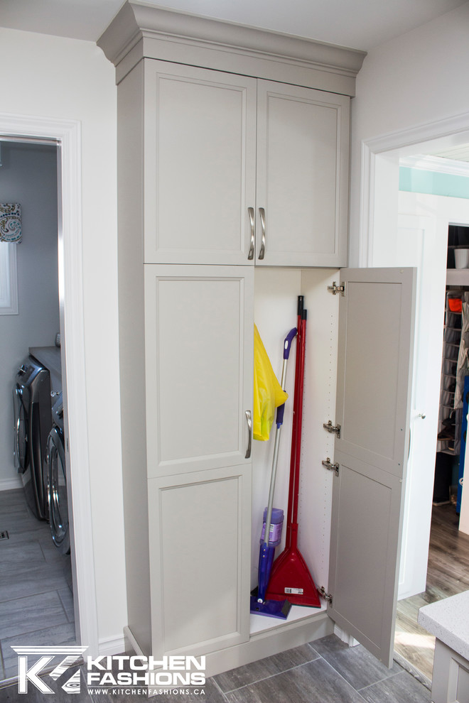 Inspiration for a mid-sized transitional single-wall ceramic tile open concept kitchen remodel with an undermount sink, shaker cabinets, gray cabinets, solid surface countertops, gray backsplash, mosaic tile backsplash, white appliances and an island