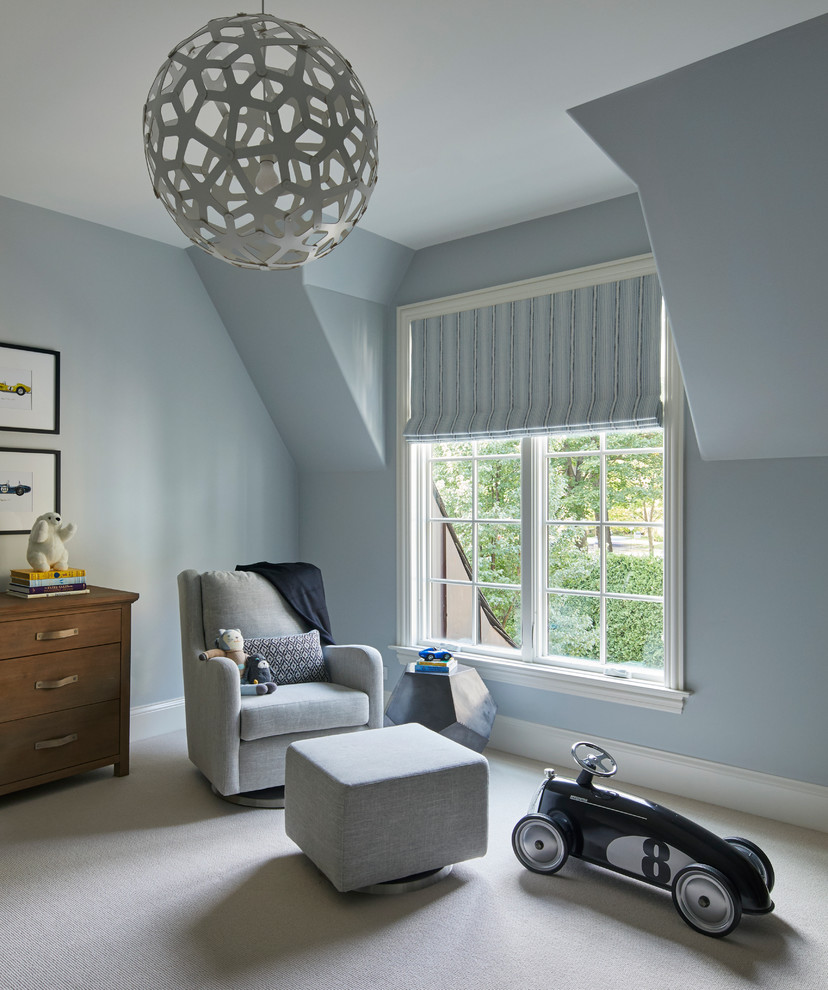This is an example of a mid-sized transitional nursery for boys in Chicago with blue walls, carpet and white floor.