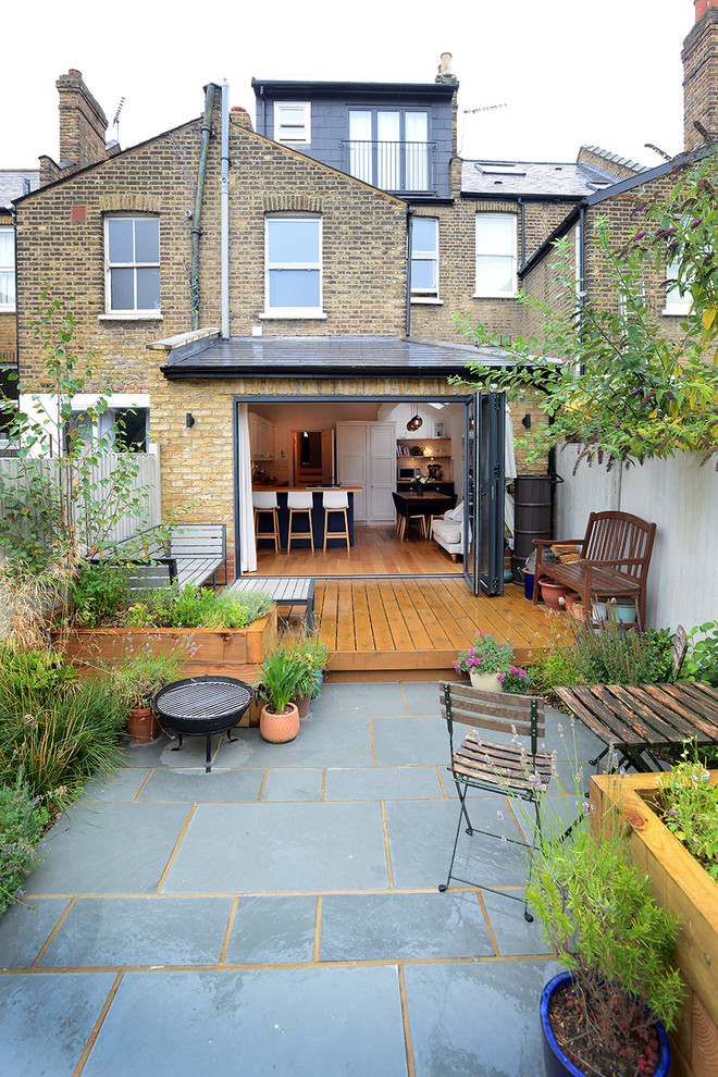 Inspiration for a traditional patio in London with a container garden and no cover.
