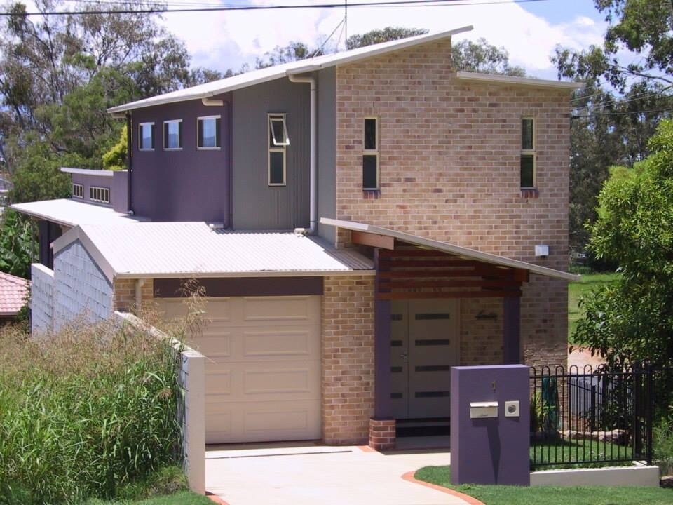 Photo of a large contemporary three-storey exterior in Brisbane with mixed siding.