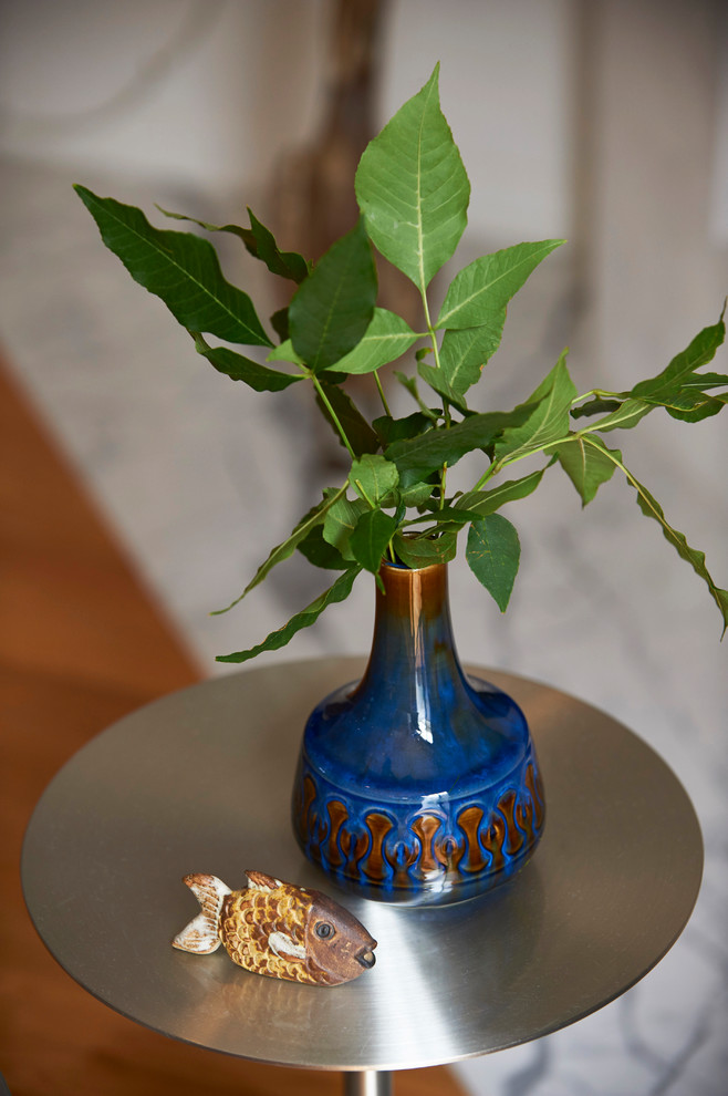 Living room - mid-sized contemporary open concept light wood floor and brown floor living room idea in Los Angeles with a bar, white walls, a corner fireplace, a plaster fireplace and a wall-mounted tv