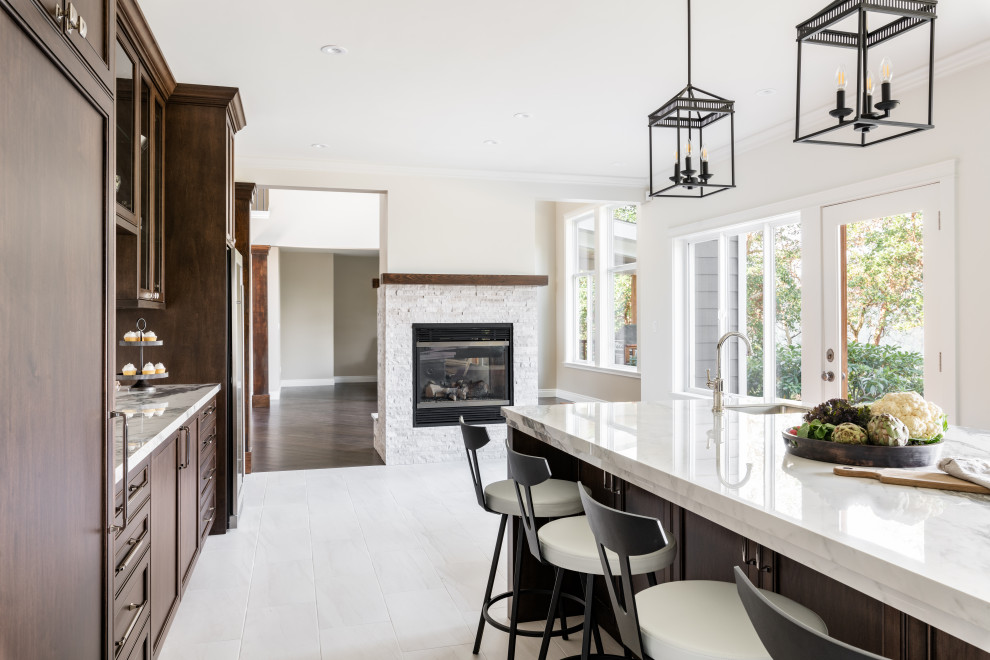 Open concept kitchen - large transitional u-shaped porcelain tile and white floor open concept kitchen idea in Vancouver with an undermount sink, recessed-panel cabinets, dark wood cabinets, quartz countertops, white backsplash, ceramic backsplash, stainless steel appliances, an island and white countertops